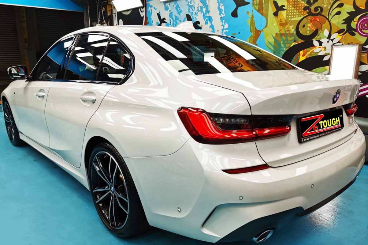 Rear quarter of the BMW 330i, glossy and protected.