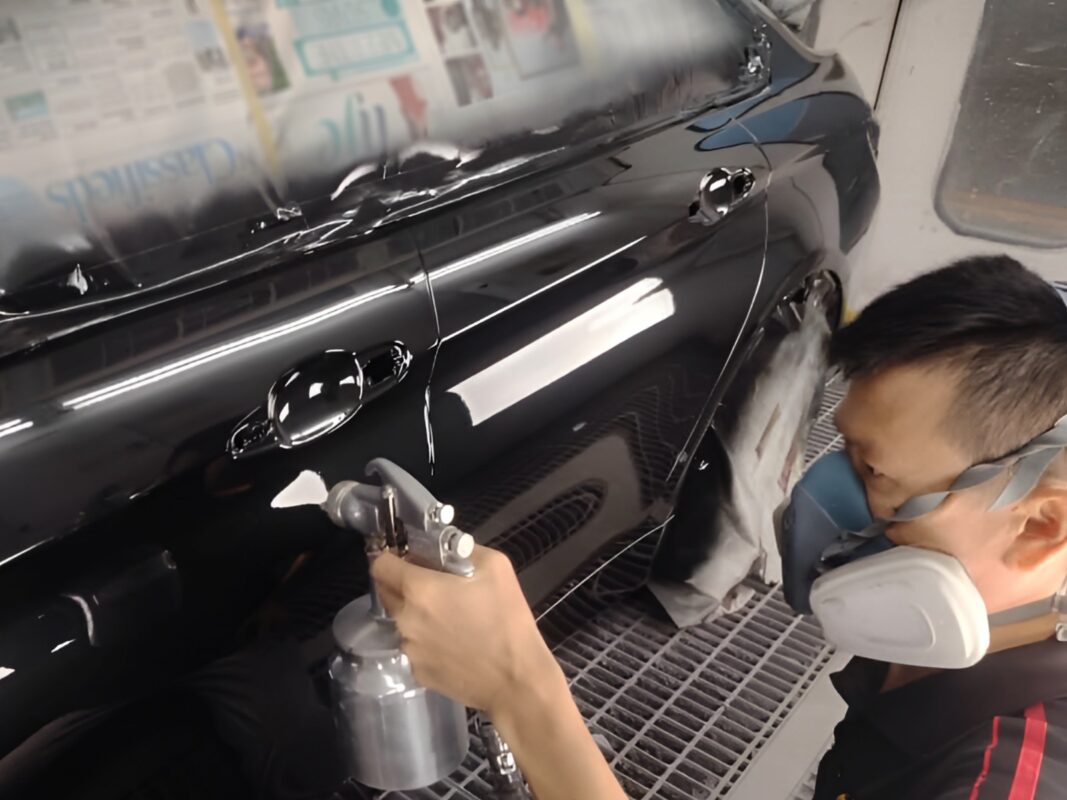 The BMW 4 Series after spraying, being sanded back for an even surface.
