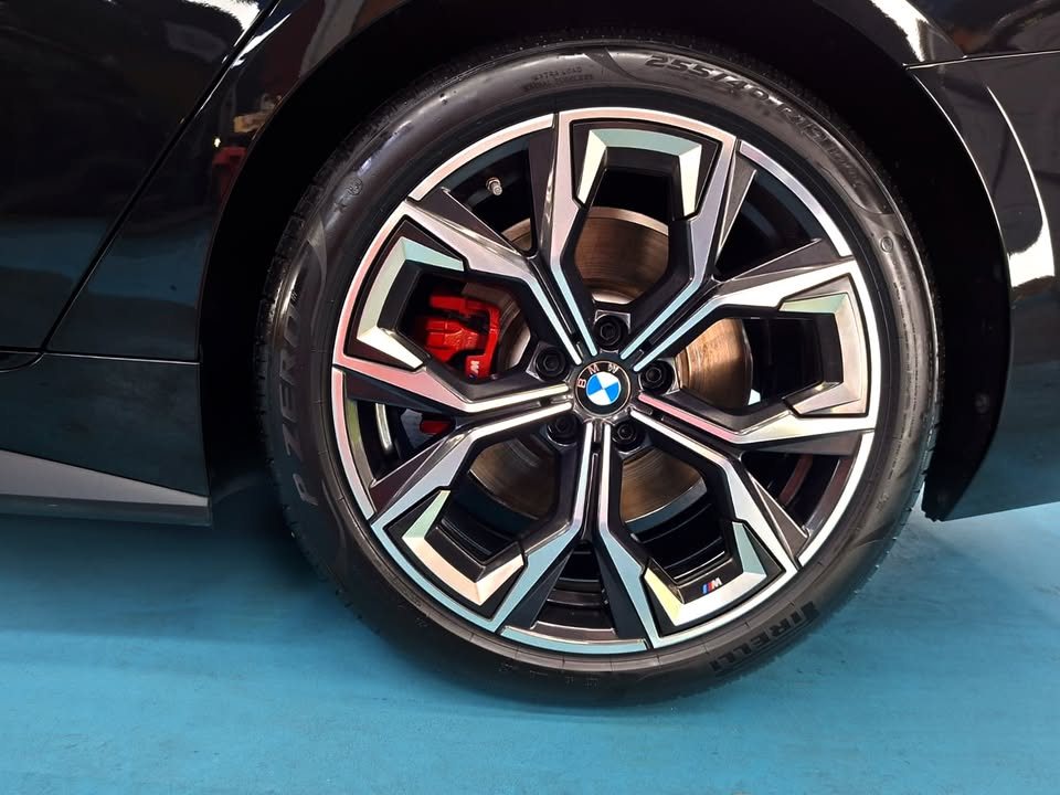 Close-up of the BMW 4 Series two-tone alloy wheel with a red brake caliper.