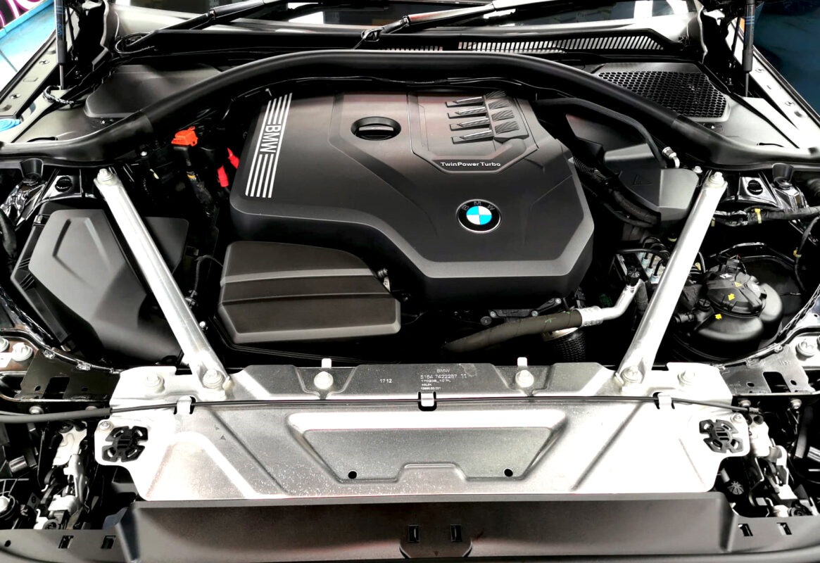 Reflections across the coated panels of the BMW 4 Series.