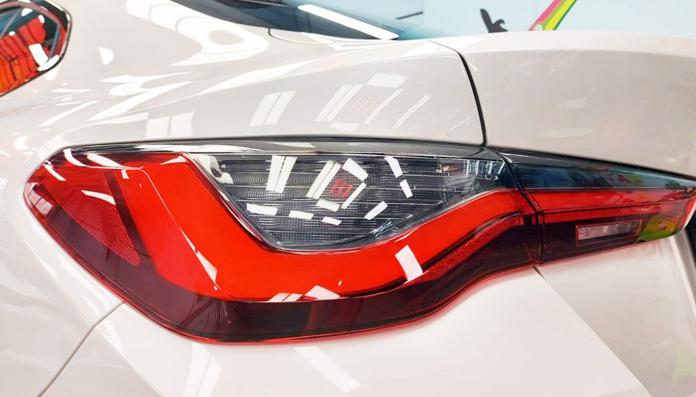 The coated bonnet of the BMW 420i under workshop lighting.