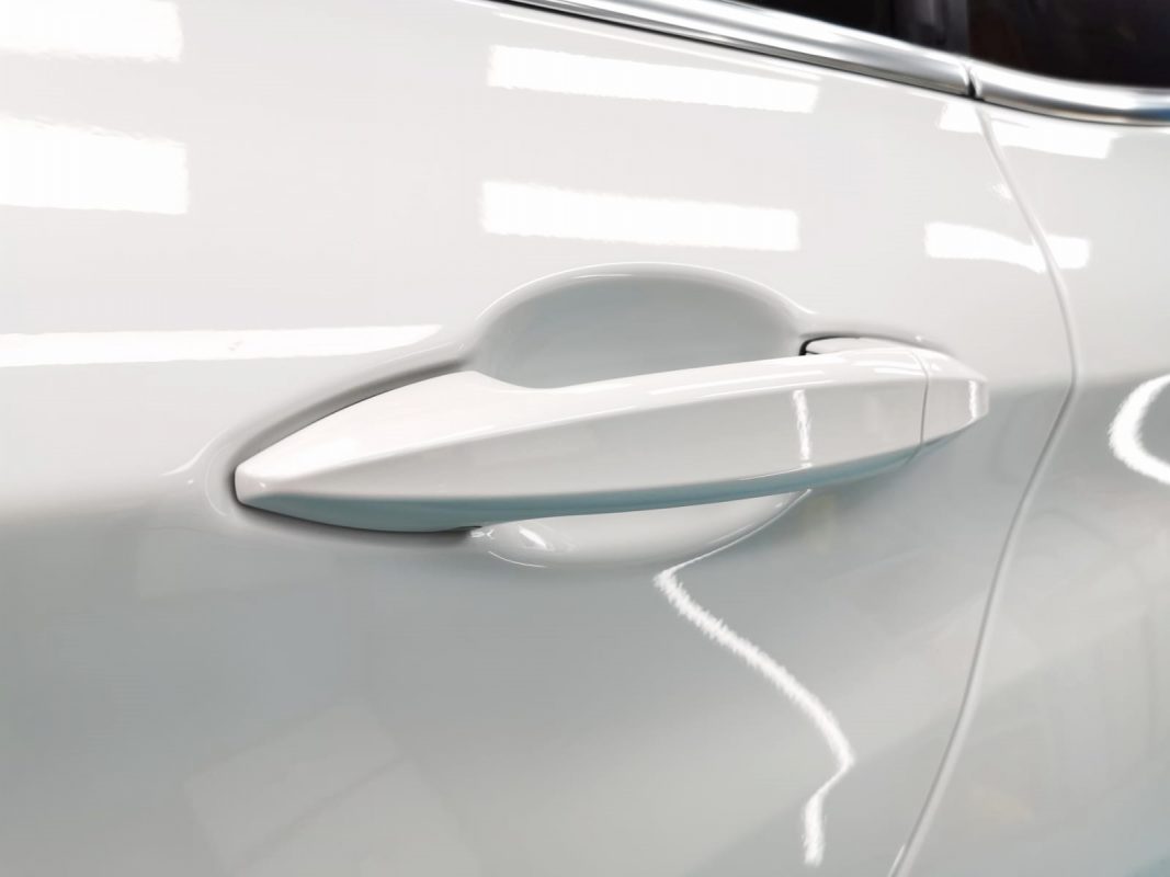 The coated bonnet of the BMW 420i under workshop lighting.