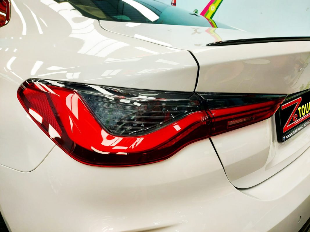 The coated bonnet of the BMW 430i under workshop lighting.