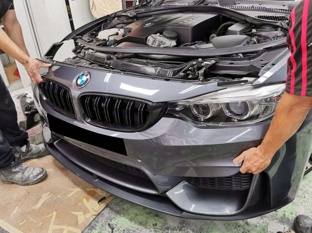 The BMW 435i stripped down on Day 2, panels and components removed.