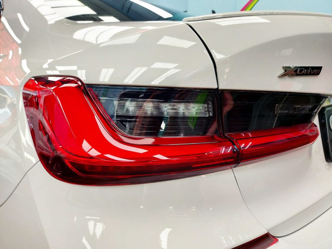 The coated bonnet of the BMW 435i under workshop lighting.