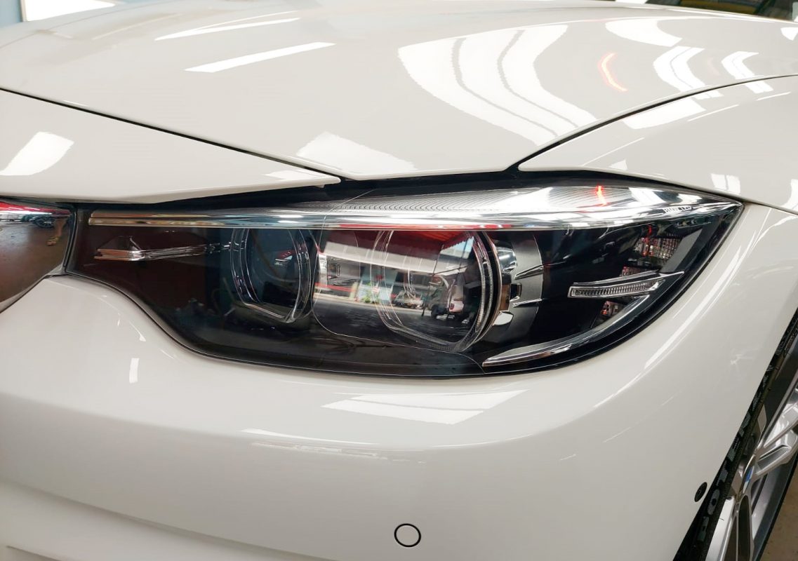 The 440i's coated paintwork holding clean reflections.