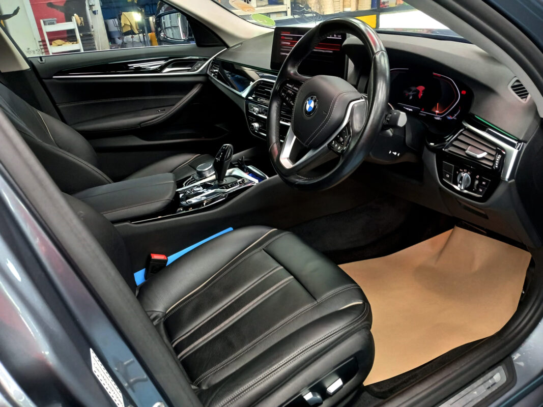 The BMW 5 Series parked in the workshop, freshly coated.