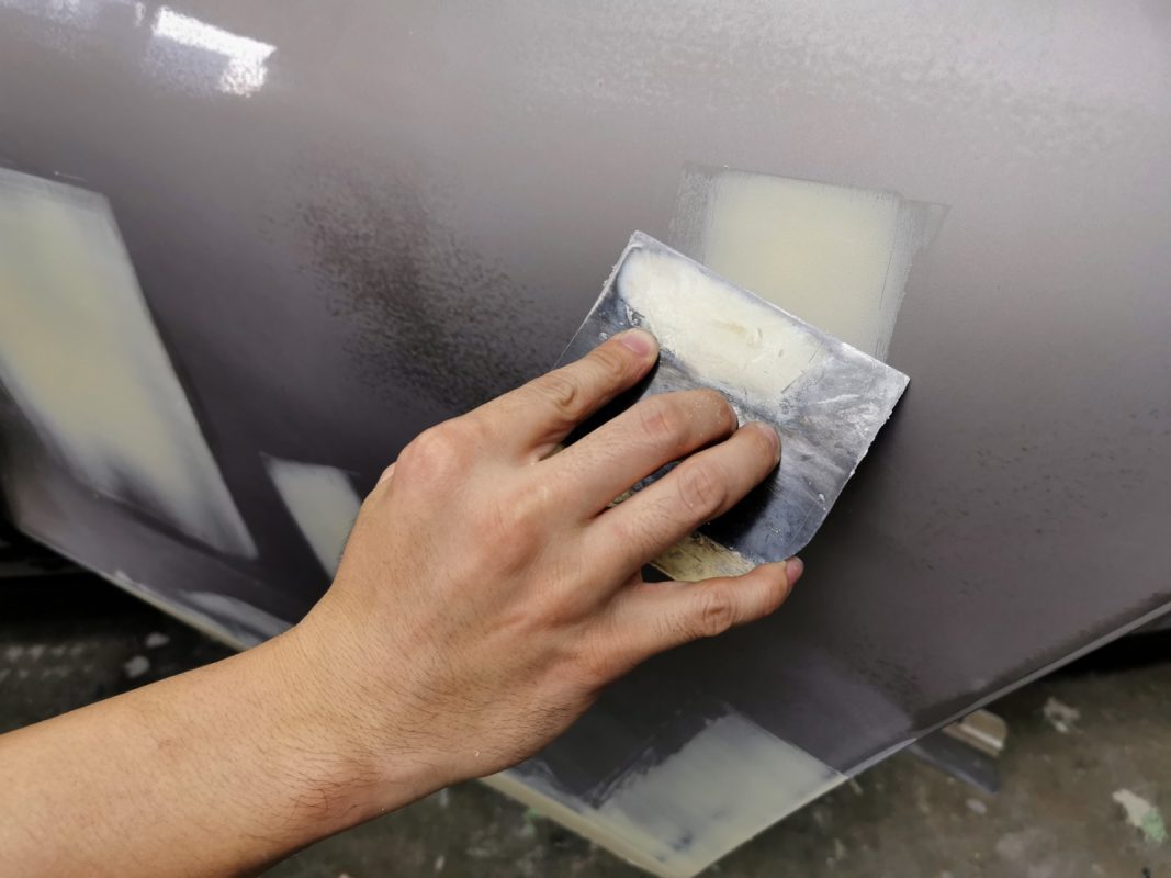 The 5 Series body being scanned and patched for scratches and dents.