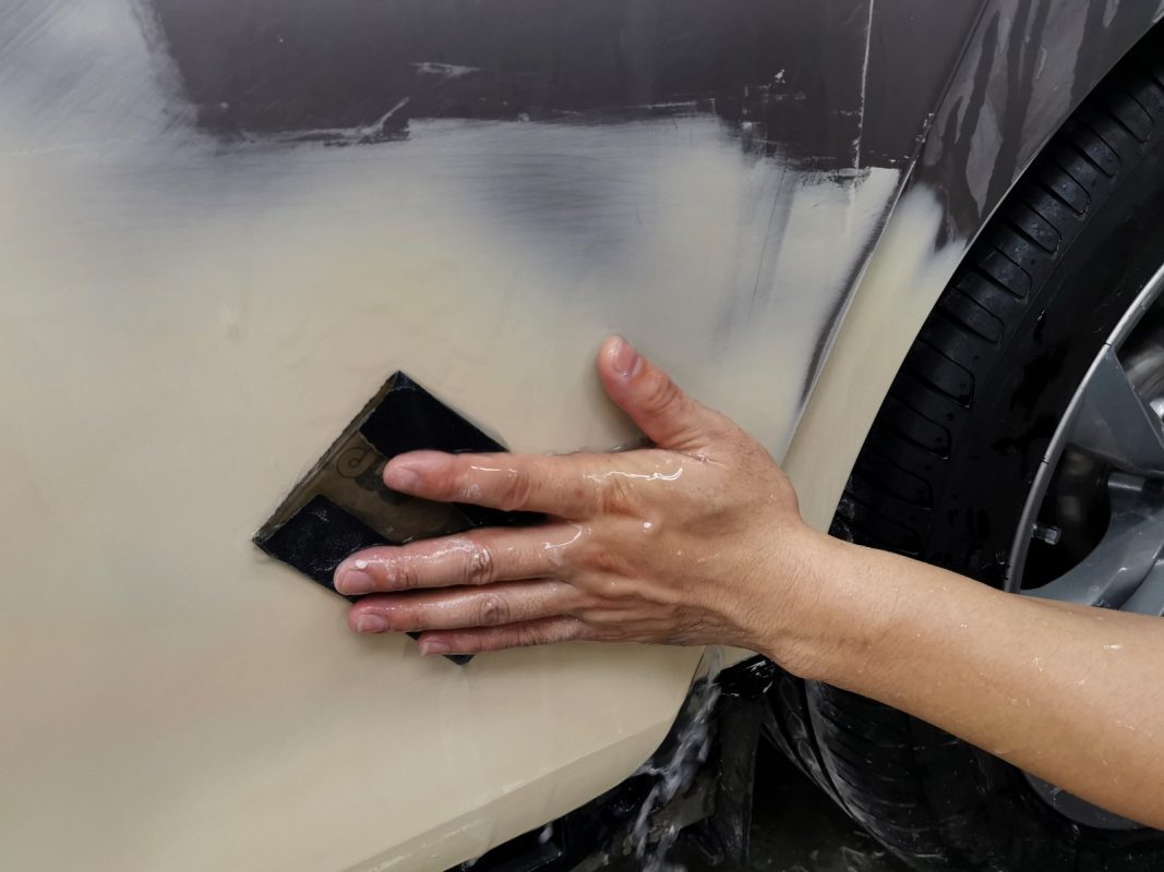 Continuing to wet-sand the body in preparation for spraying.