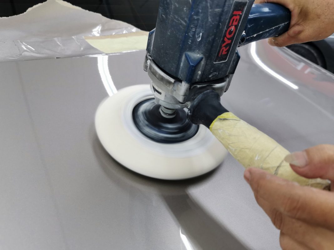 Buffing the new paint on the 5 Series to bring up the shine.