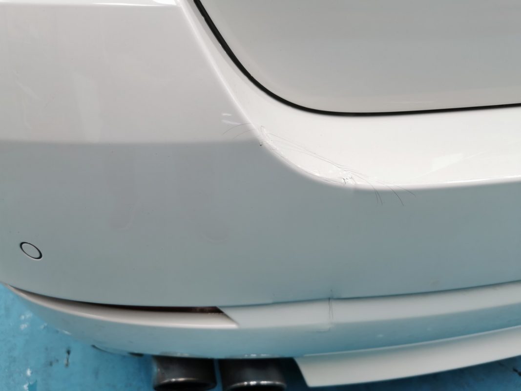 Paintwork in need of repair on the BMW 5 Series at intake.