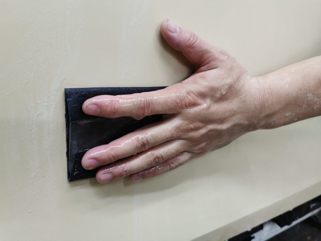 Wet-sanding the 5 Series' panels to smooth the existing paintwork.