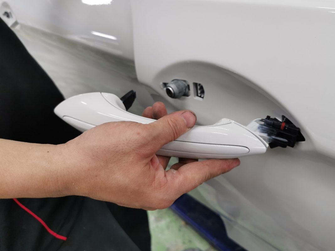 Polishing the new paint on the 5 Series to bring up the shine.