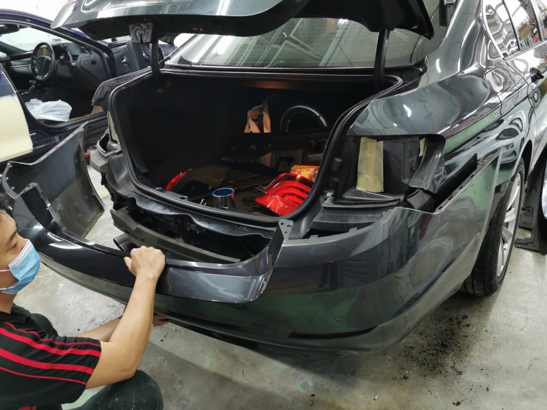 Car parts being dismantled from the 5 Series before spraying.