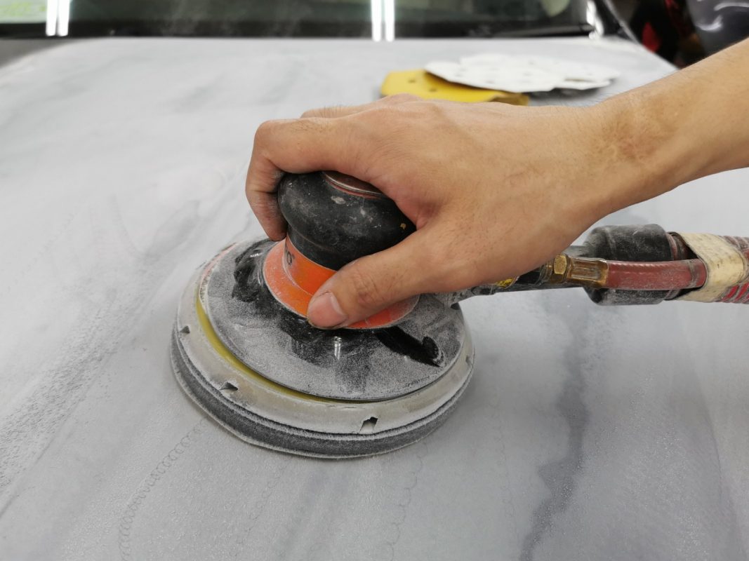 The car's surface inspected and patched where the paintwork was imperfect.
