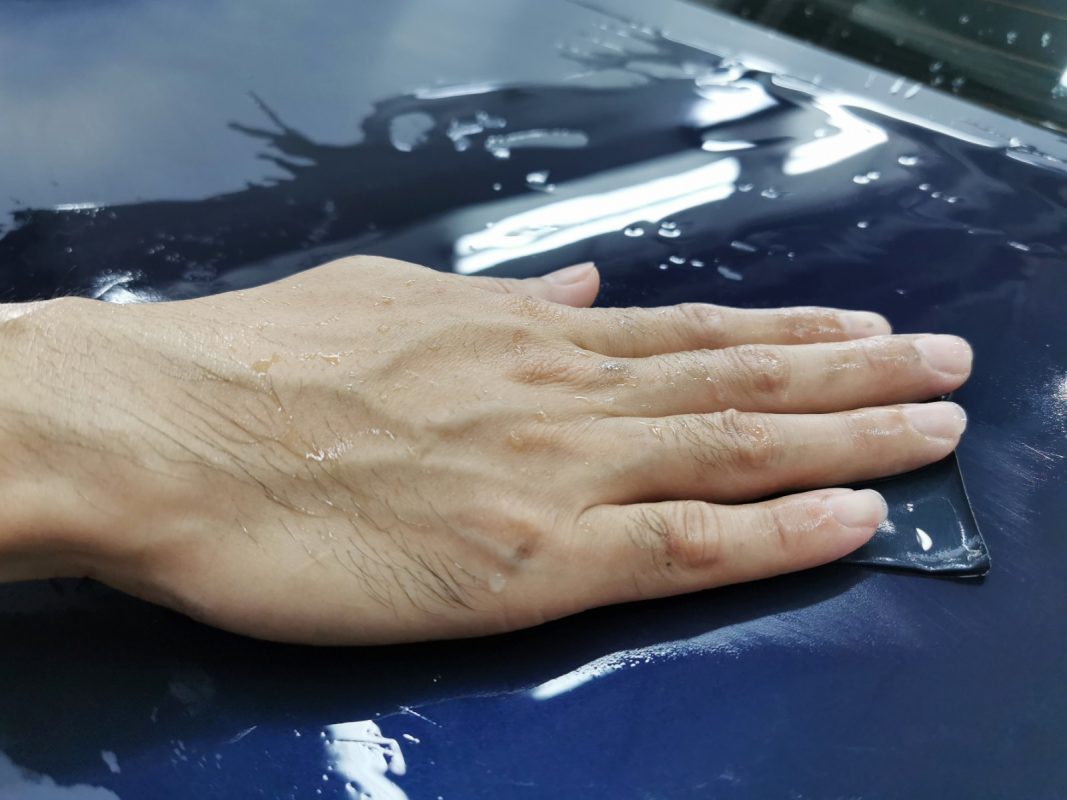 Wet-sanding the 5 Series panels to smooth the existing paintwork.