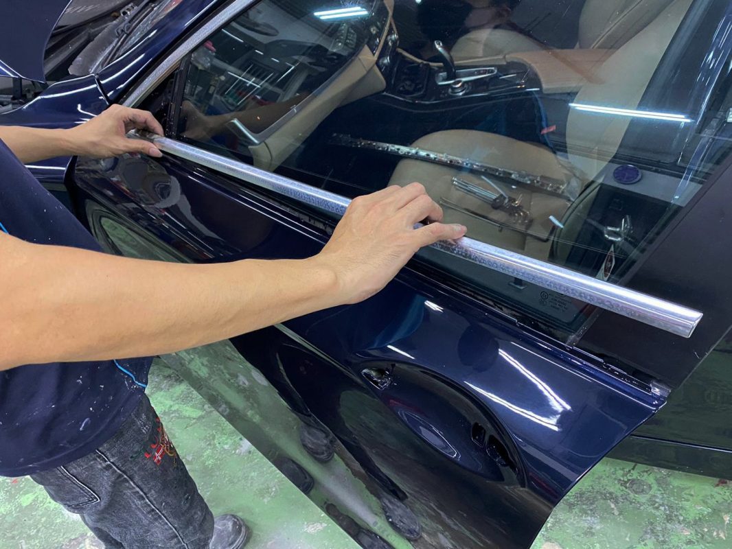 Buffing the new paint on the 5 Series to bring up the shine.