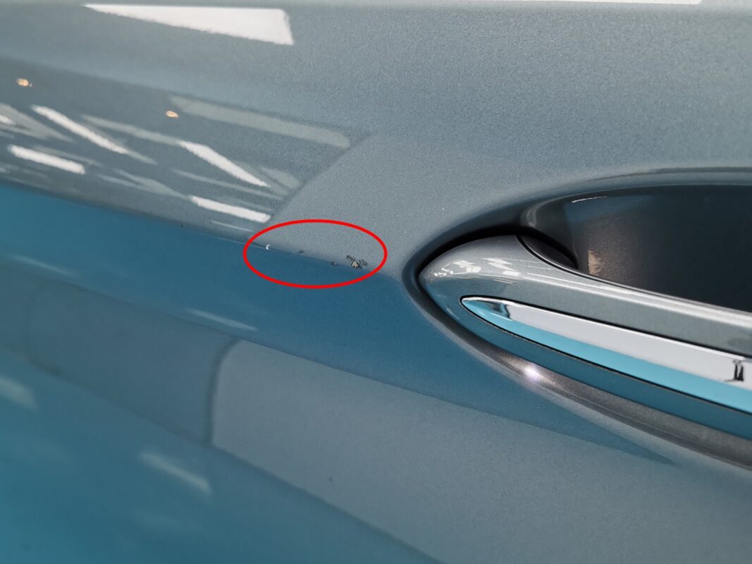 Paint peel-off and stone chips on the BMW 5 Series body panels, before any work.