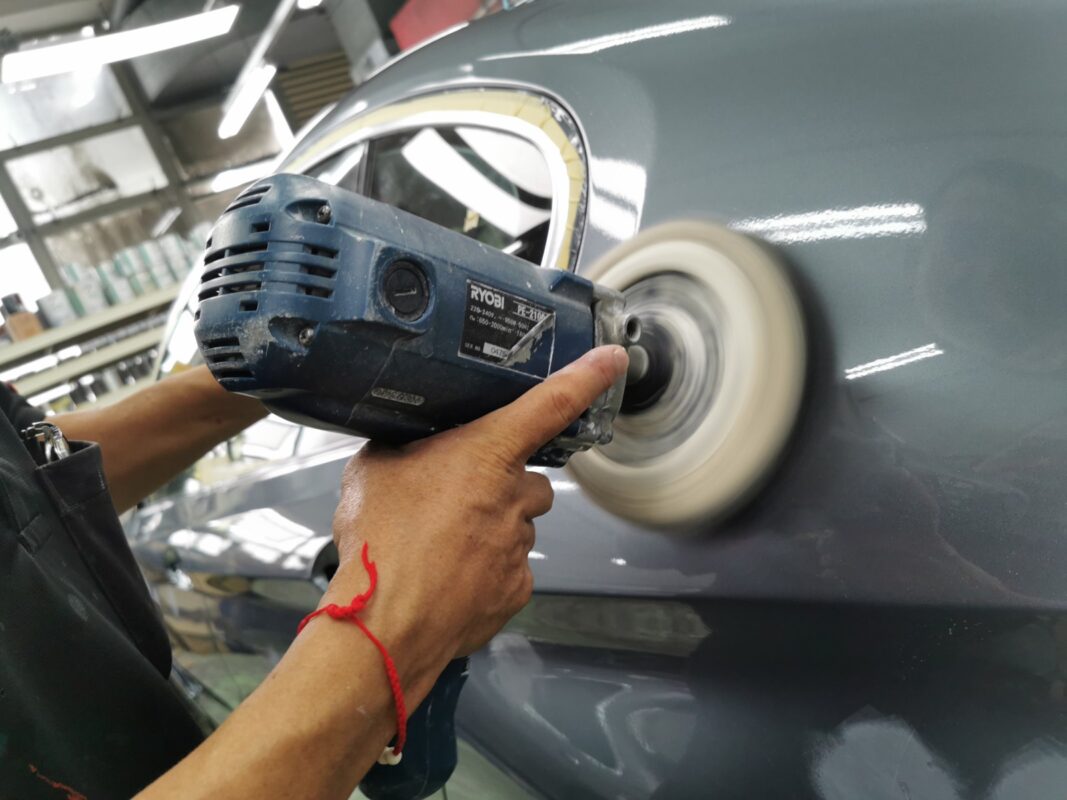 The spray booth at Revol Carz, new paint being laid on the BMW 5 Series panels.