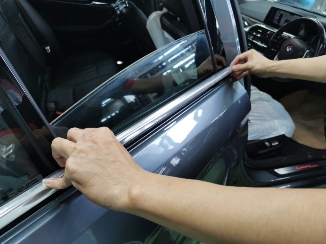 Wet sanding and polishing the BMW 5 Series after the paint coat to bring up smoothness.
