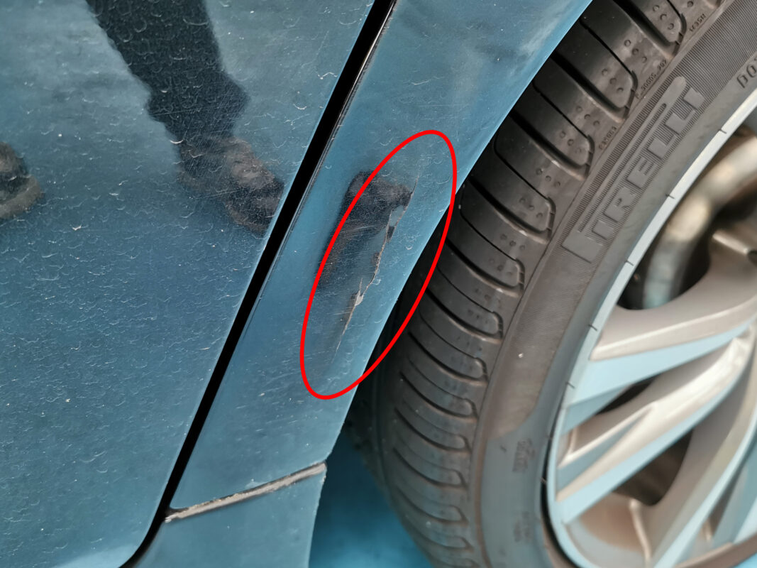 Side view of the BMW 5 Series on arrival, paintwork worn and scarred.