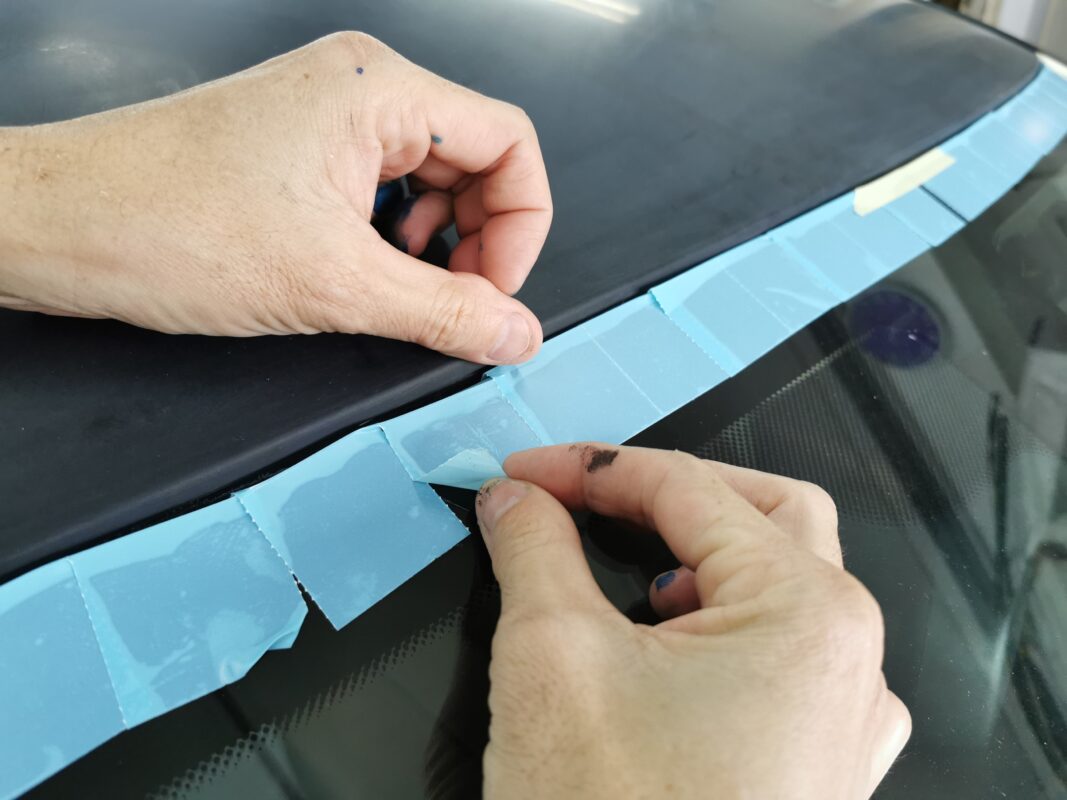 Masking detail showing bumper and trim carefully covered.