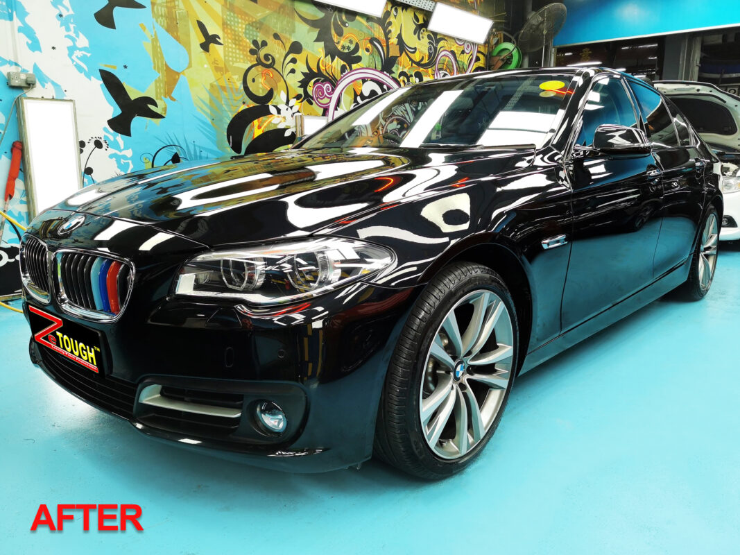 The BMW 5 Series from a second angle after the respray is complete.