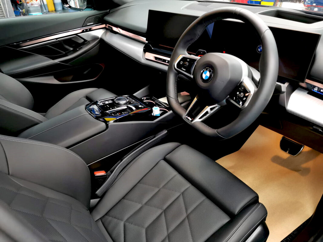 The BMW 5 Series parked in the workshop, freshly coated.