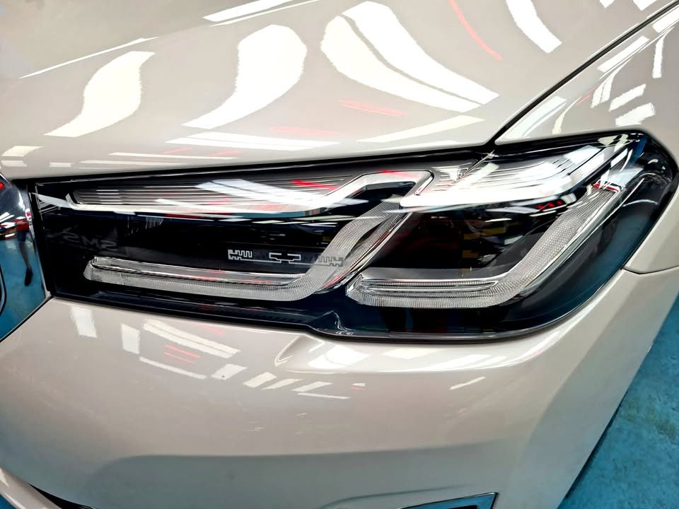 Close-up of the 5 Series headlight in white bodywork.