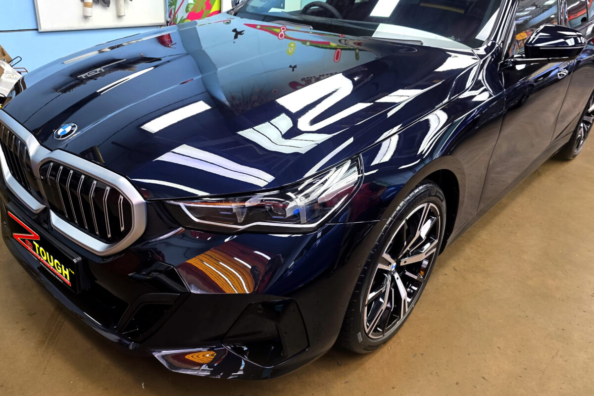 The BMW 5 Series's coated paintwork under workshop lighting.