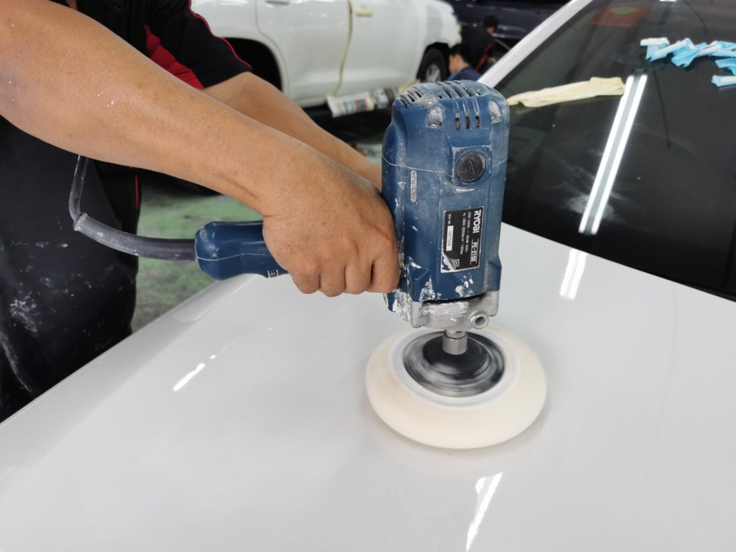 The 520D being wet-sanded again after spraying for an even surface.