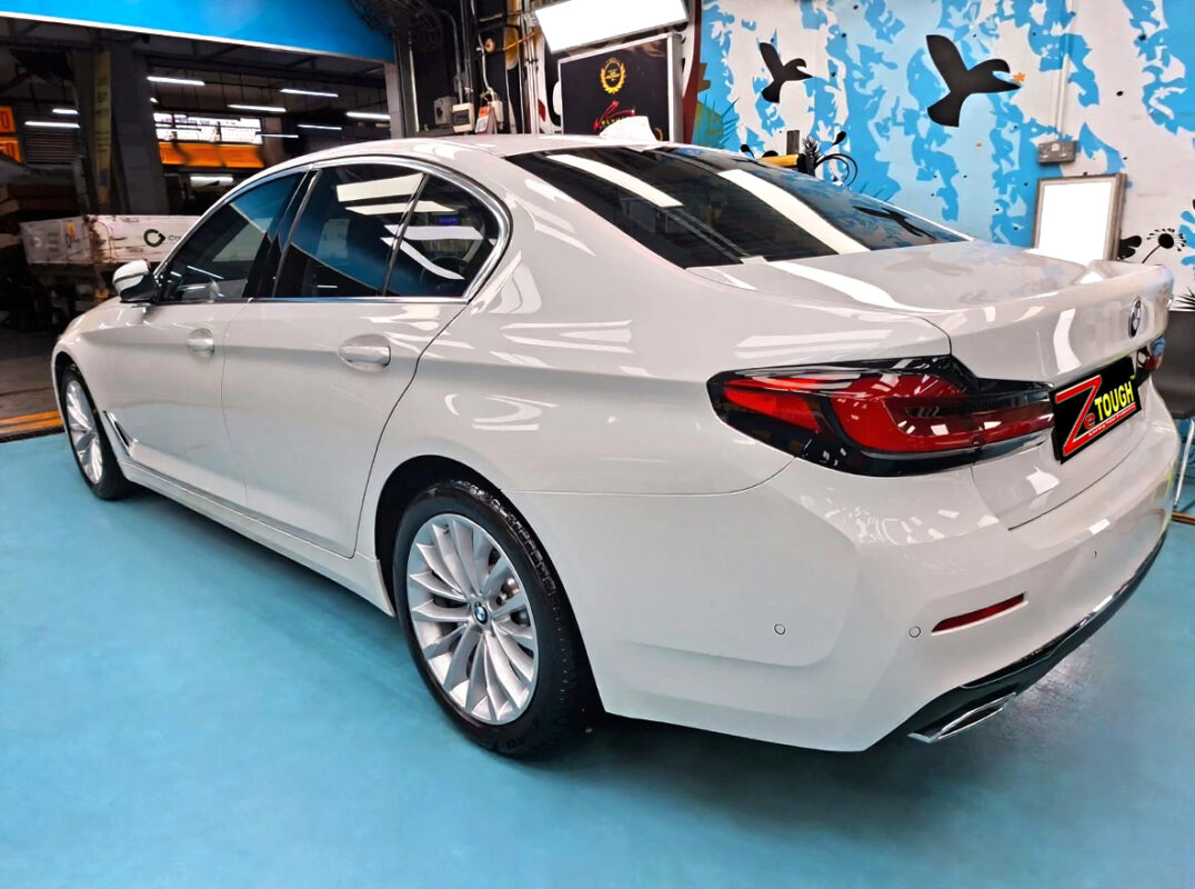 Rear quarter of the BMW 520i, glossy and protected.
