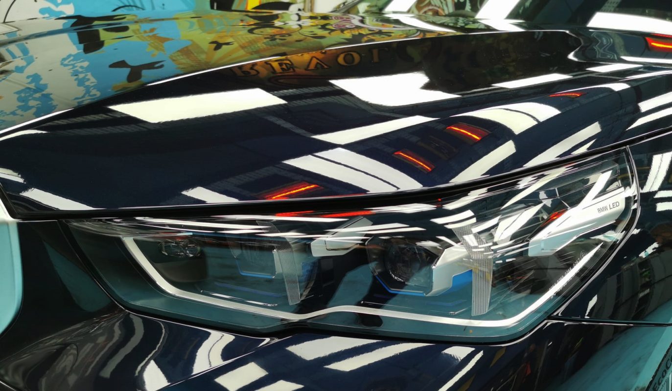The 520i's coated paintwork showing clean reflections.