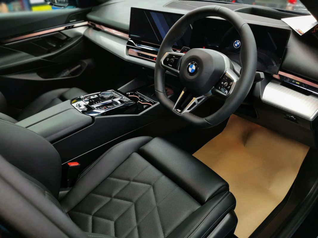 The BMW 520i parked in the workshop, freshly coated.