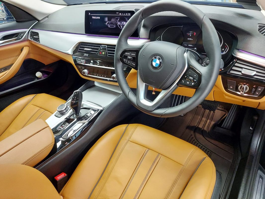 The BMW 520i parked in the workshop, freshly coated.