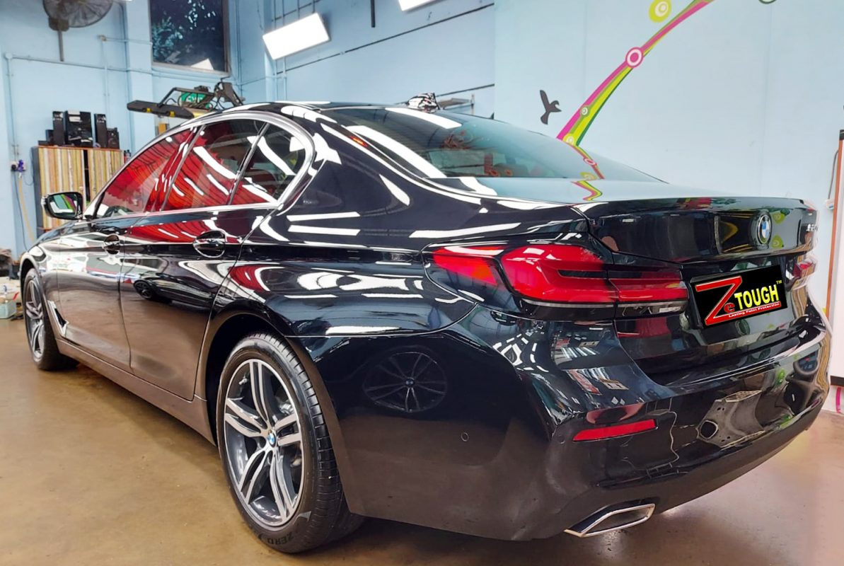 Rear quarter of the BMW 520i, glossy and protected.