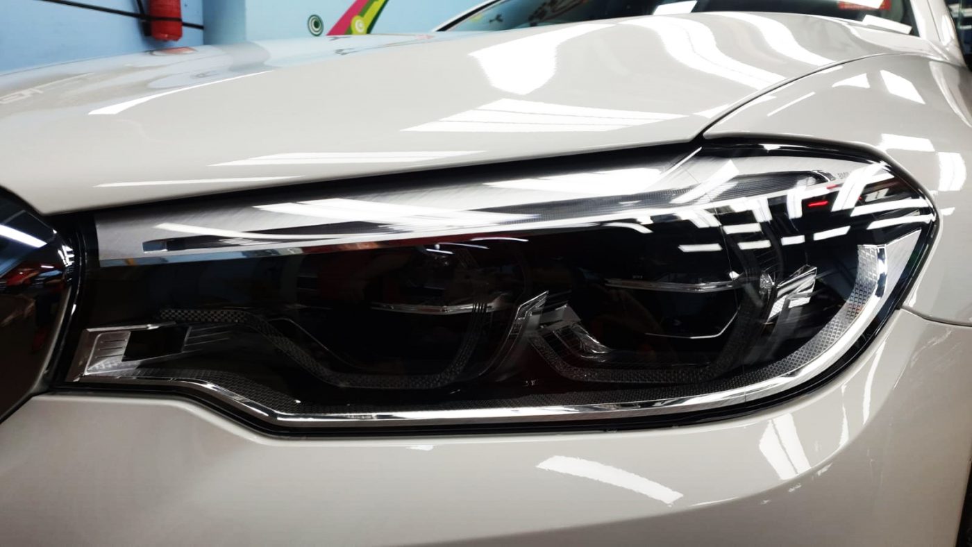 The 520i's coated paintwork showing clean reflections.