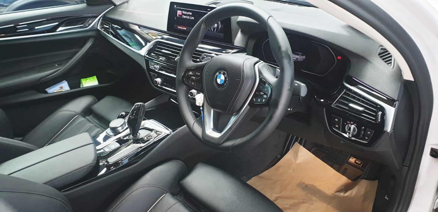 The BMW 520i parked in the workshop, freshly coated.