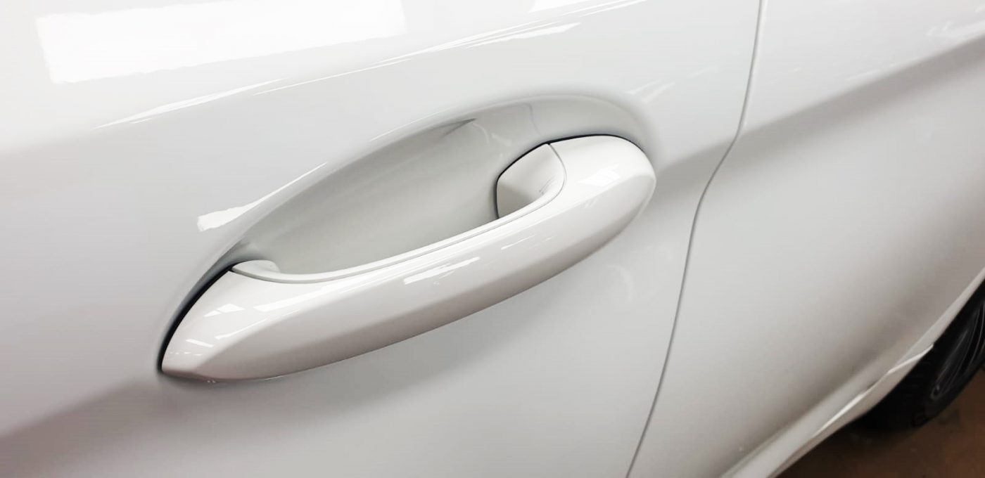 Front three-quarter view of the BMW 520i after coating.