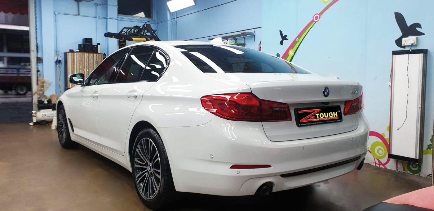 Rear quarter of the BMW 520i, glossy and protected.