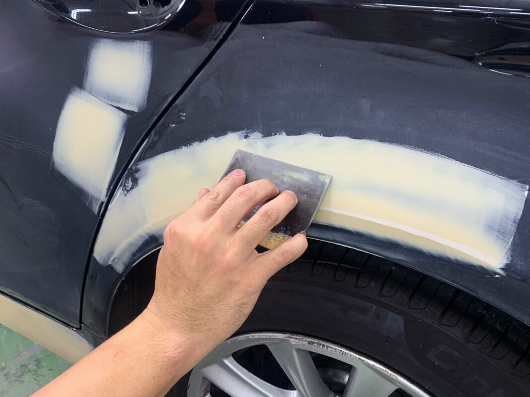 Bodywork underway on the BMW 520i, sanding and patching on Day 3.