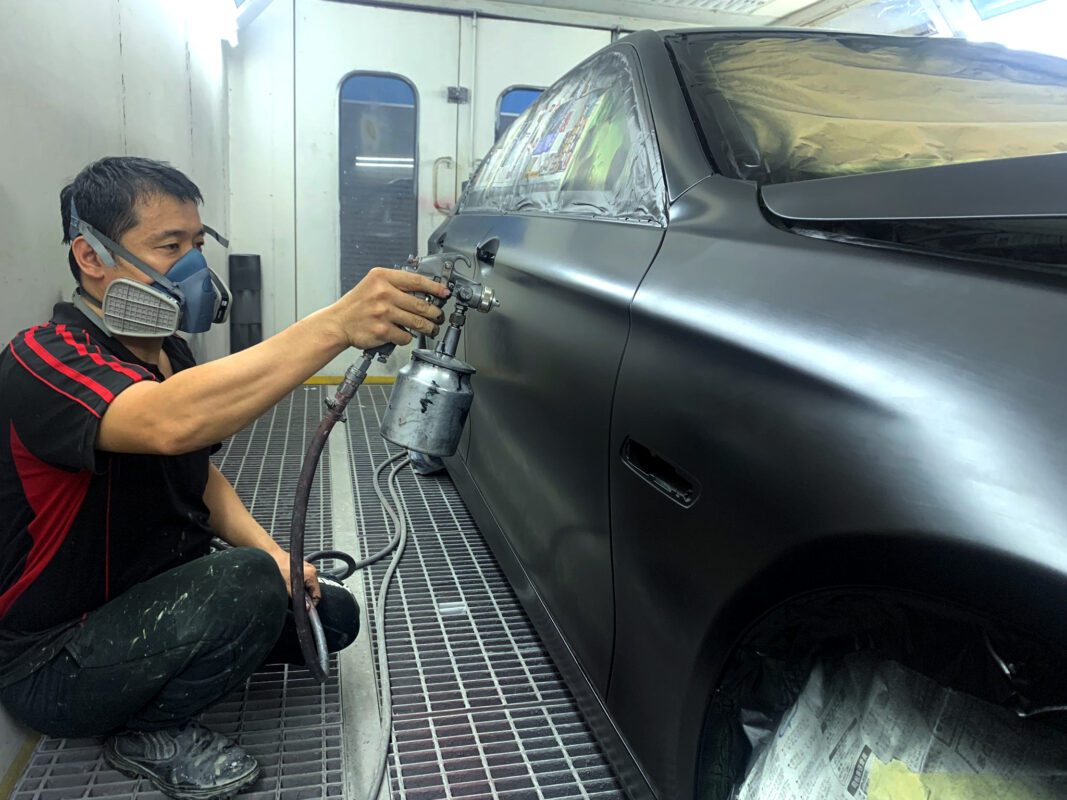 Polishing the BMW 520i after the paint has been laid, bringing up the gloss.