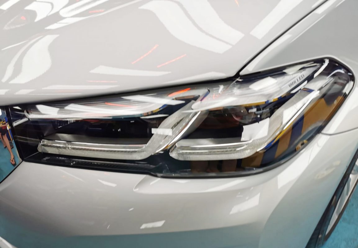 The 520i's coated paintwork showing clean reflections.