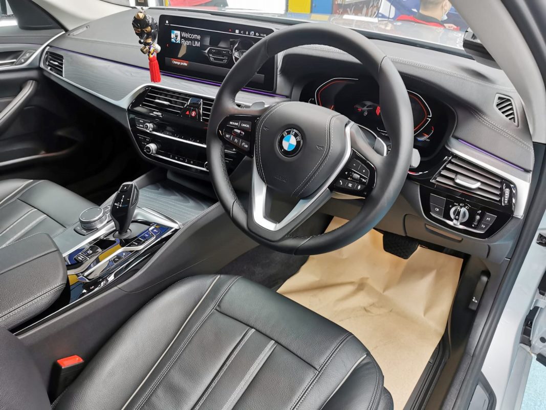 The BMW 520i parked in the workshop, freshly coated.