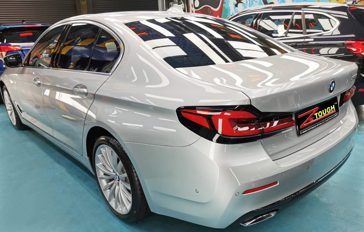 Rear quarter of the BMW 520i, glossy and protected.