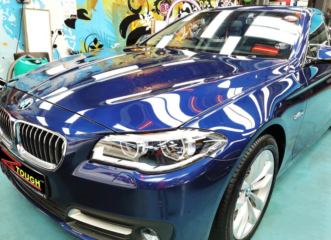The BMW 520i from a side angle after the titanium coating.