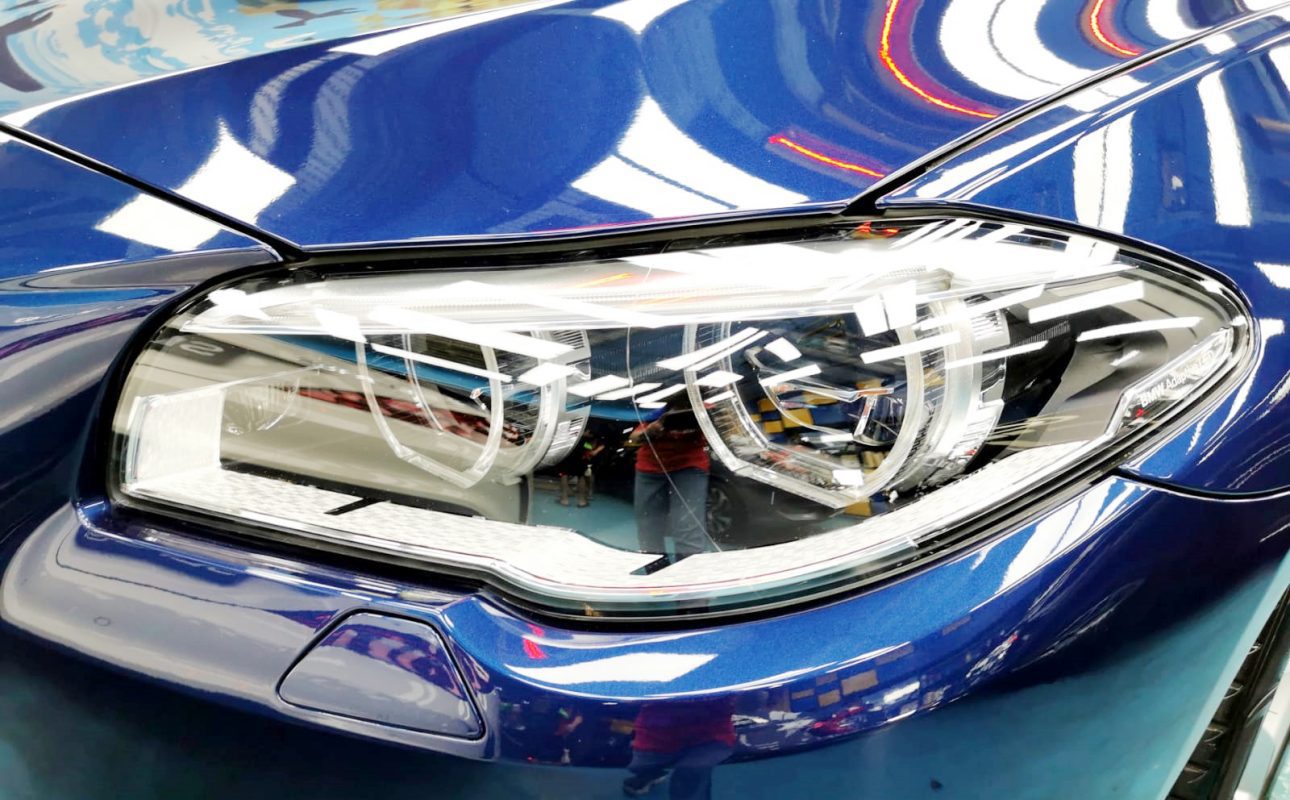 The 520i's coated paintwork showing clean reflections.