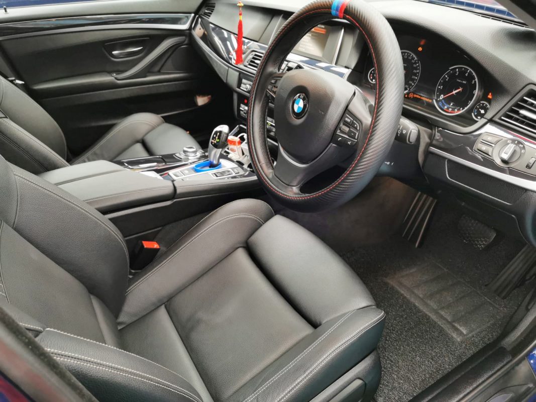 The BMW 520i parked in the workshop, freshly coated.
