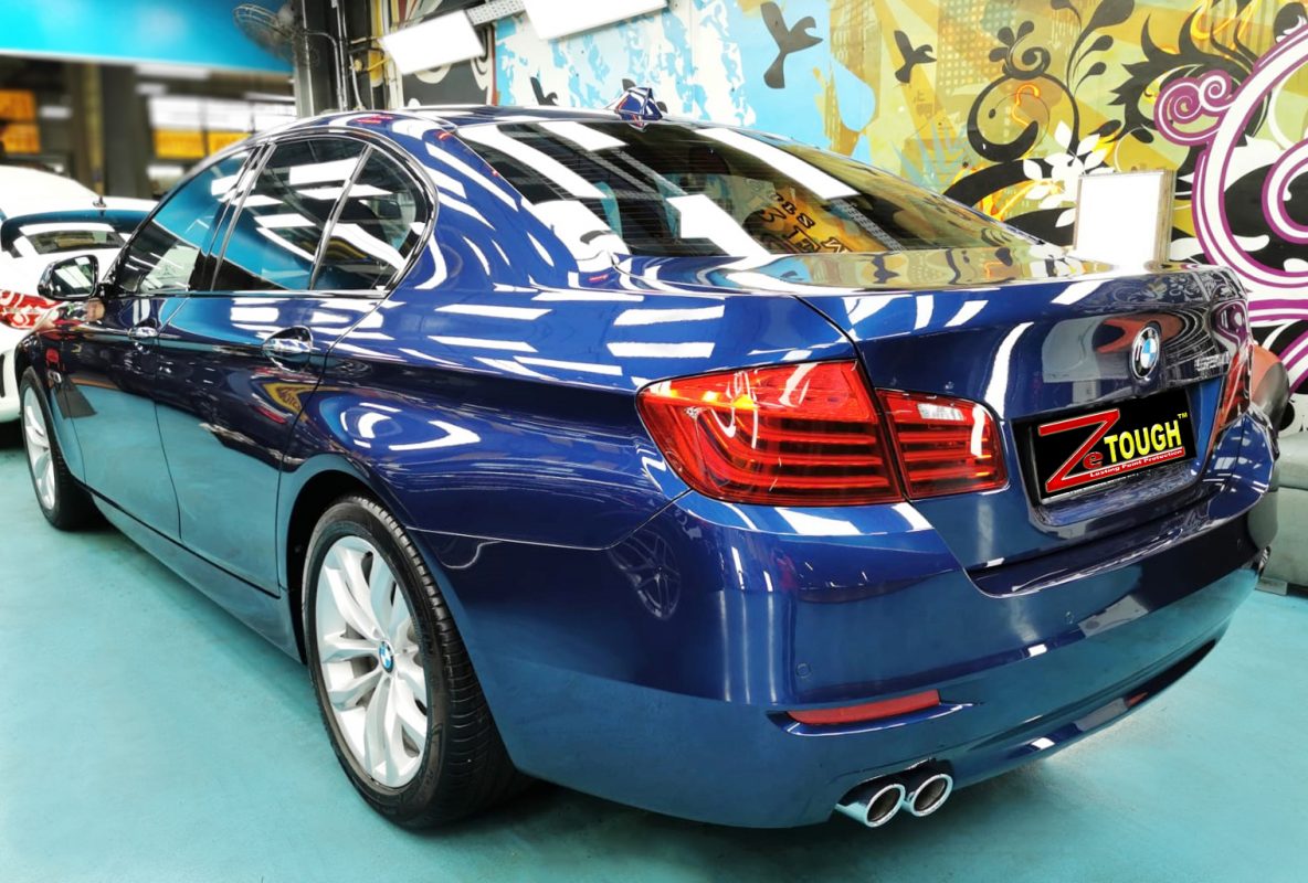 Rear quarter of the BMW 520i, glossy and protected.