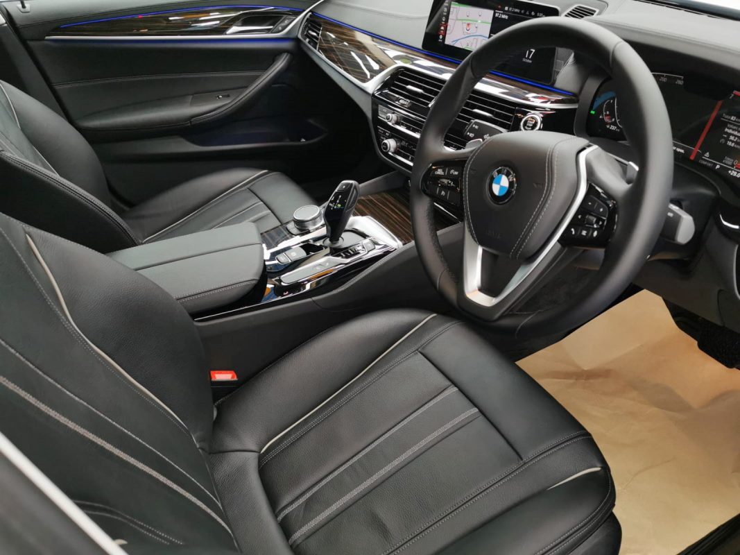 The BMW 520i parked in the workshop, freshly coated.